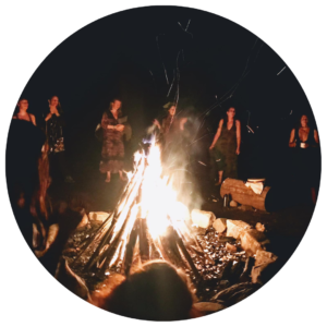 Women celebrate and are wild around a fire